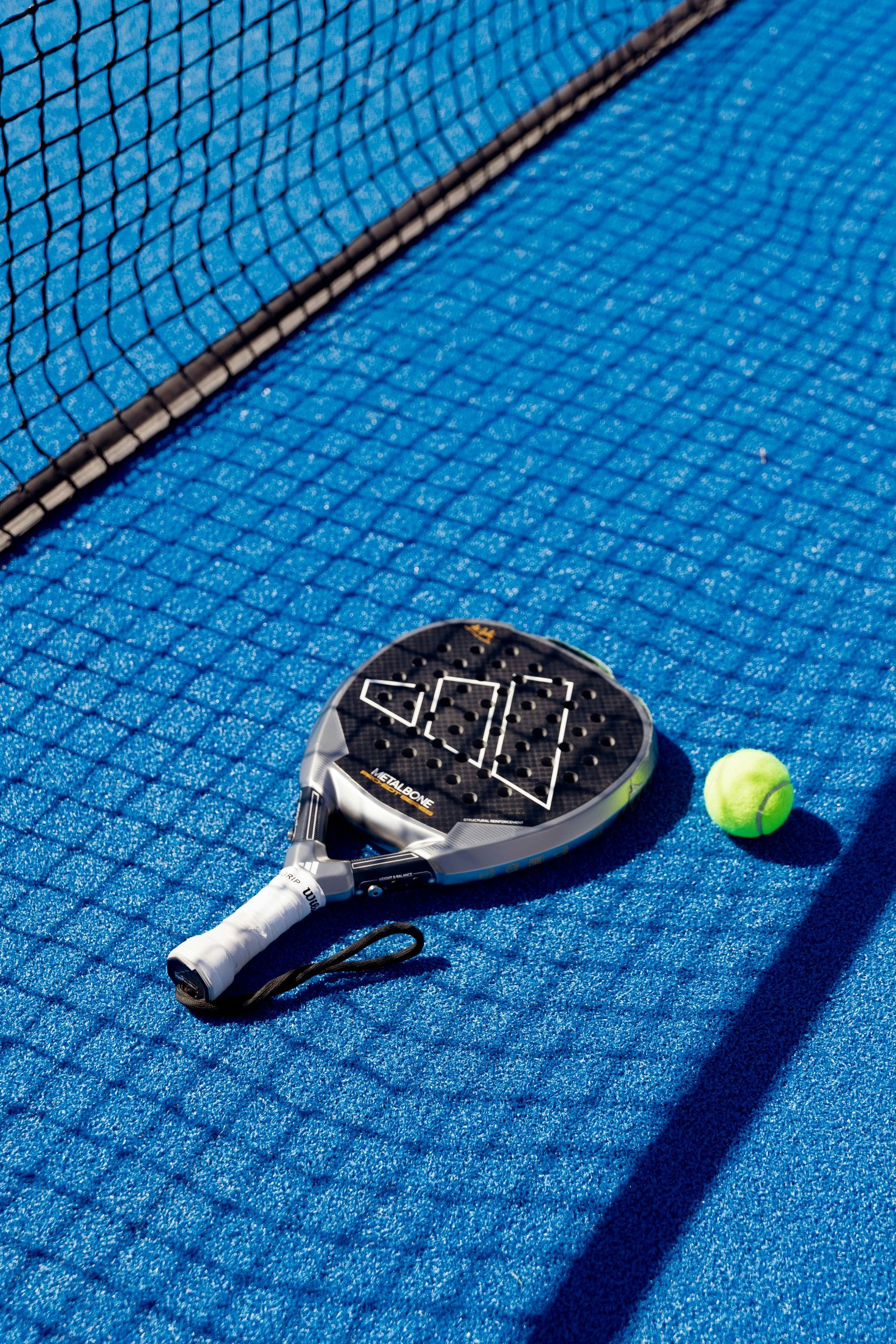 An aerial view of a tennis court surrounded by trees