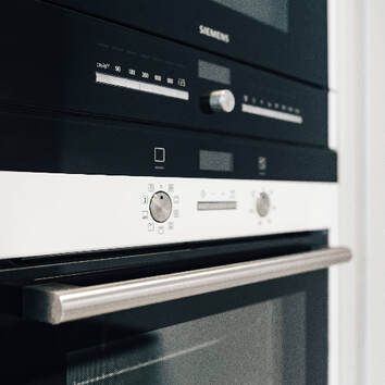 A close up of a siemens oven and microwave.