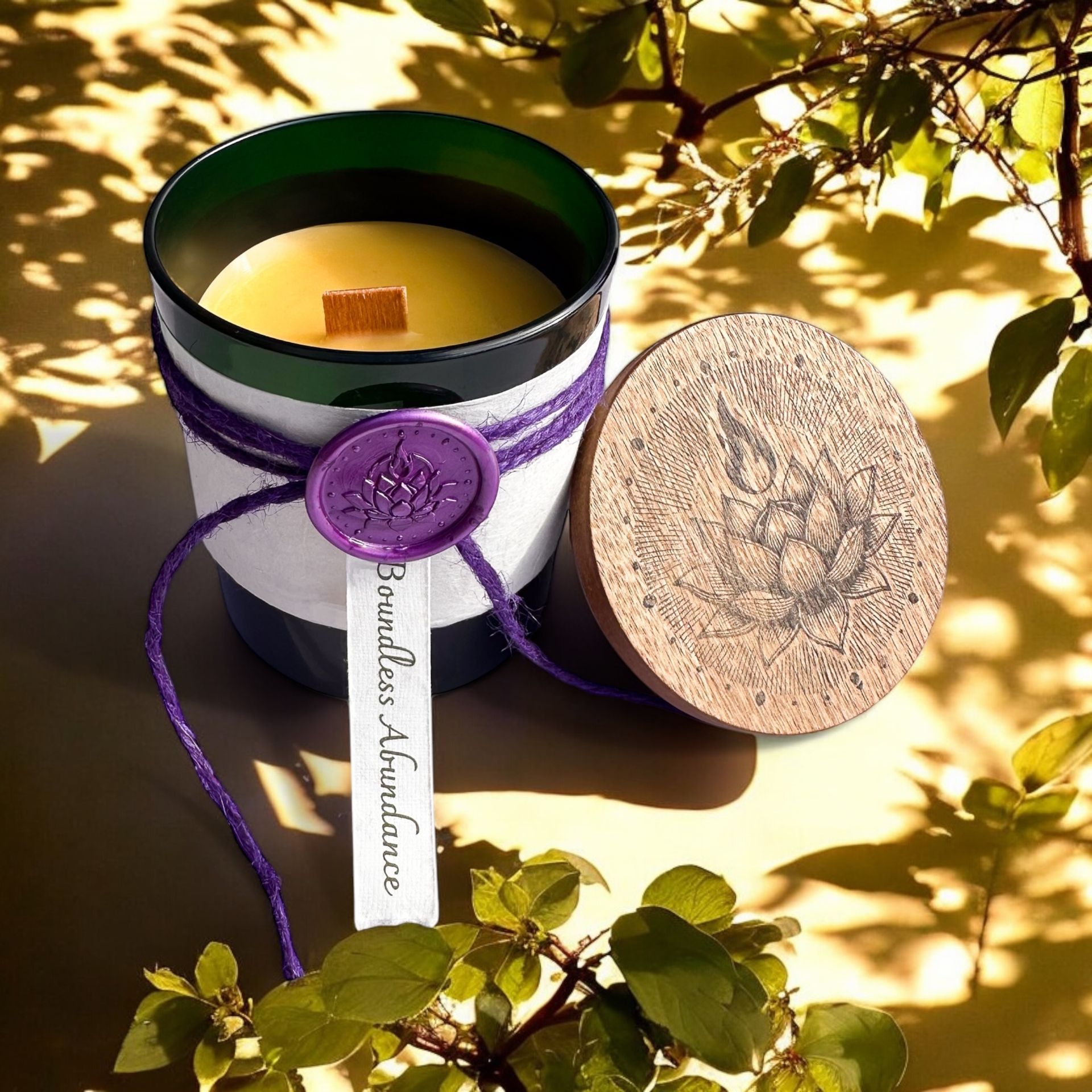 Boundless Abundance candle by Eldara, nestled among leaves and deep shadows. Infused with green aventurine to invite grounding, growth and quiet prosperity.
