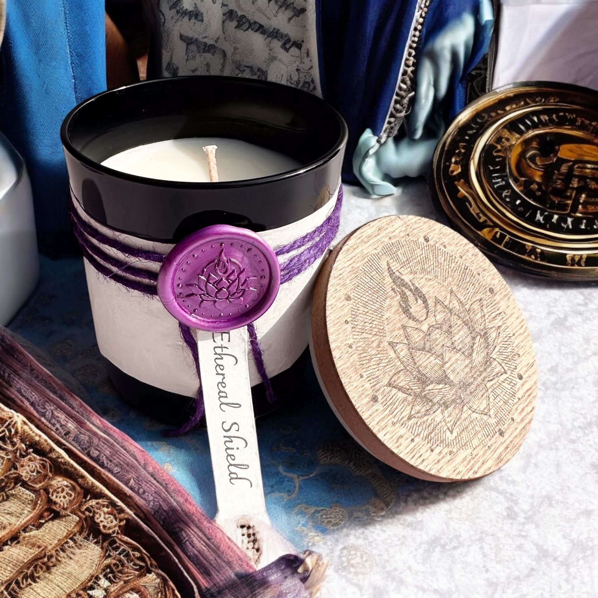 Open Ethereal Shield candle by Eldara, displayed on a velvet altar cloth with Wiccan symbols. Infused with black tourmaline for protection, grounding and sacred energy.