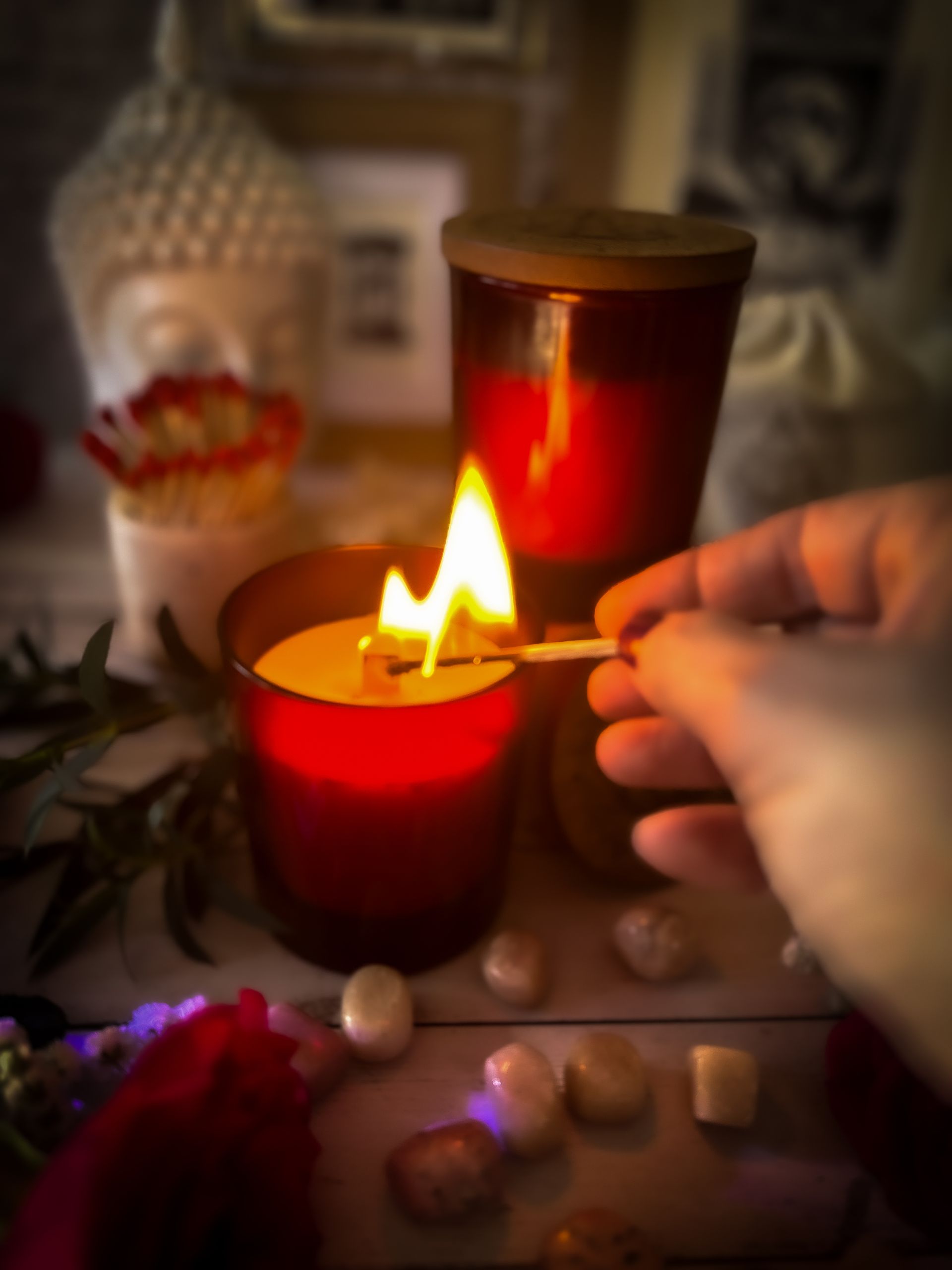 Lighting the Sacred Desire ritual candle by Eldara, hand-poured with carnelian crystal and sacred oils to awaken creativity, courage and sensual energy.