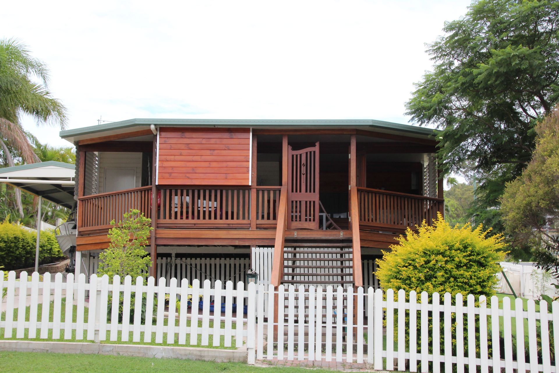 Wooden house with porch behind a white picket fence — Bob Ryan's Home Improvements & Construction Pty Ltd in Beecher, QLD