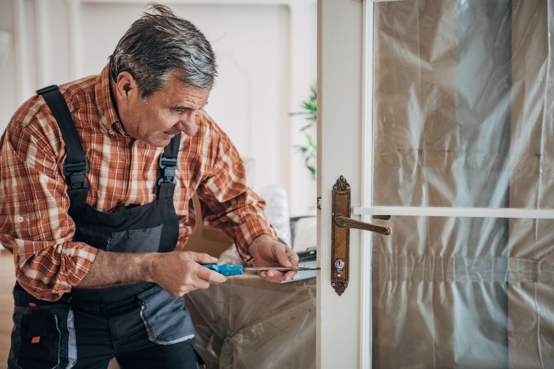 Carpenter repairing the door.