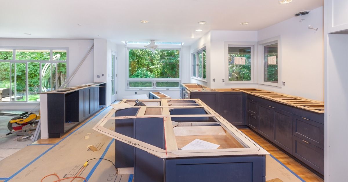 A kitchen under renovation with lower cabinets and a large island.
