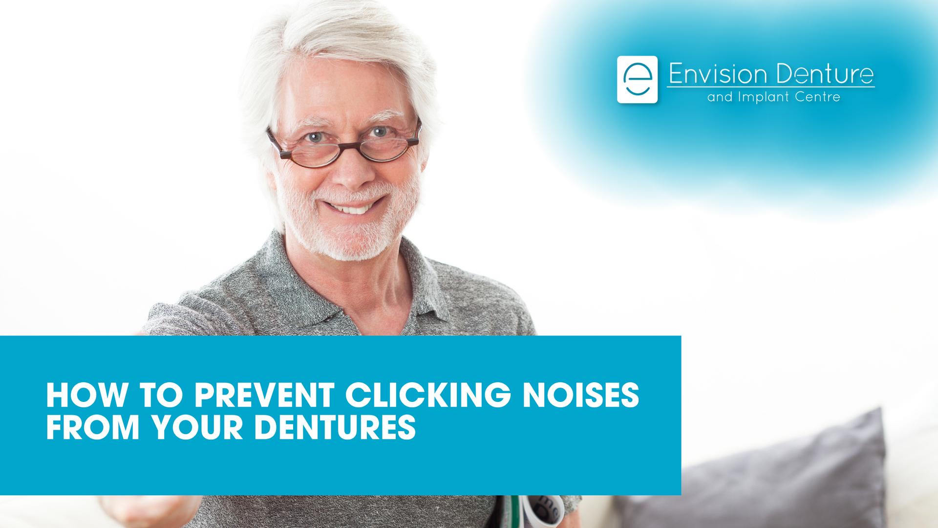 An older man wearing glasses and dentures is smiling for the camera.