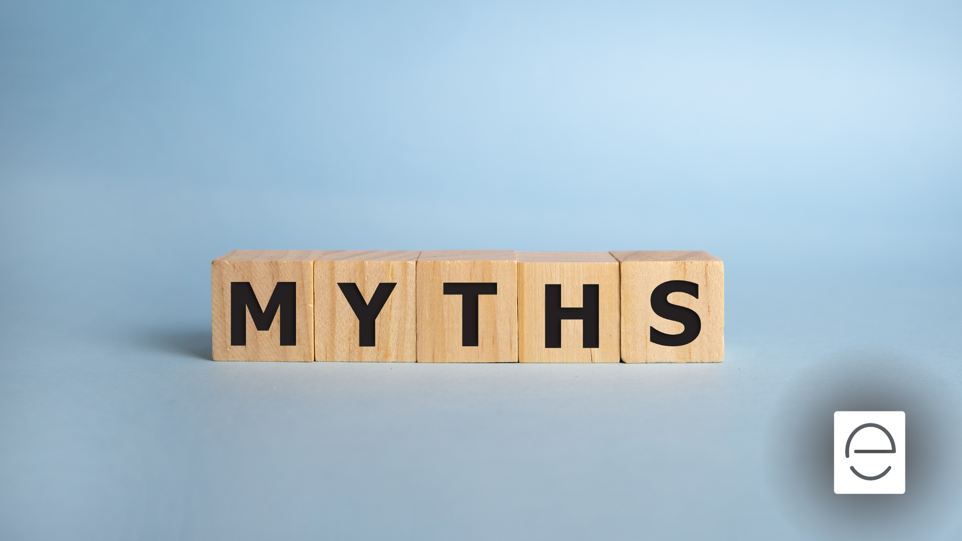 The word myths is written on wooden blocks on a blue background.