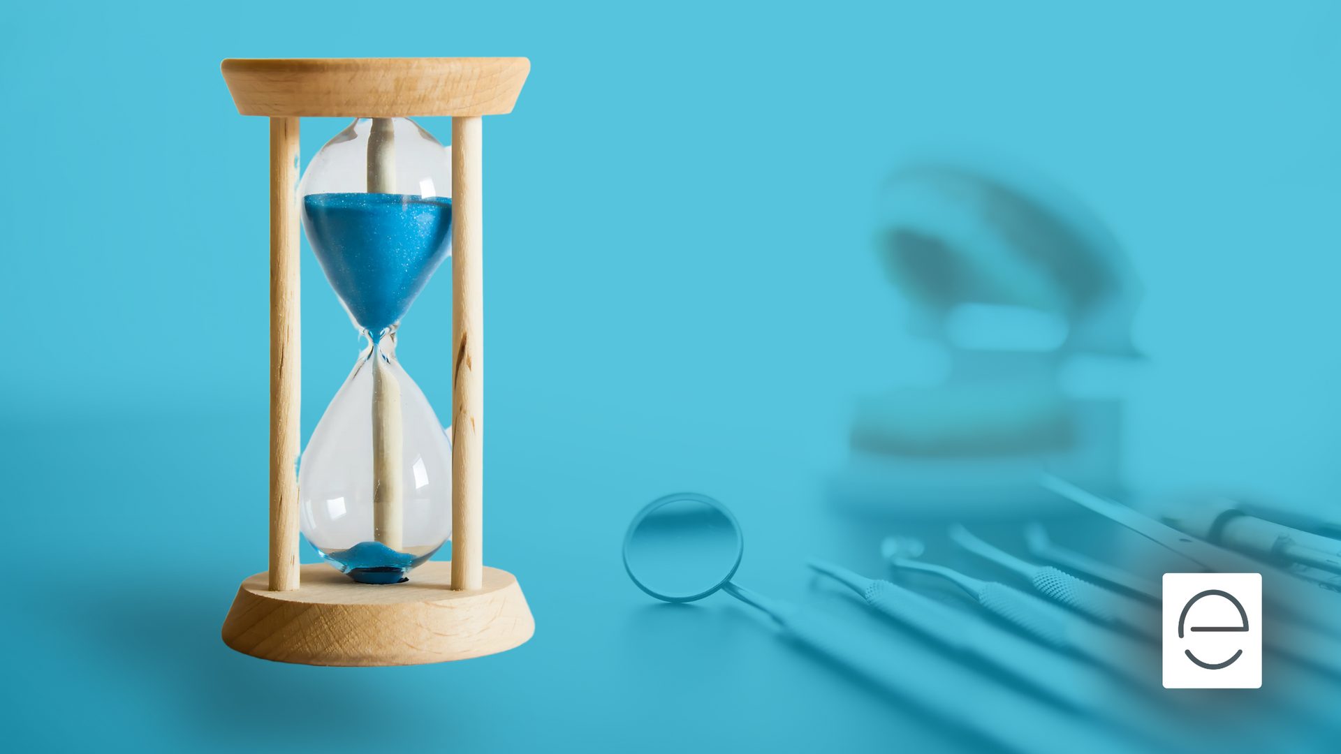 An hourglass and dental instruments on a blue background.