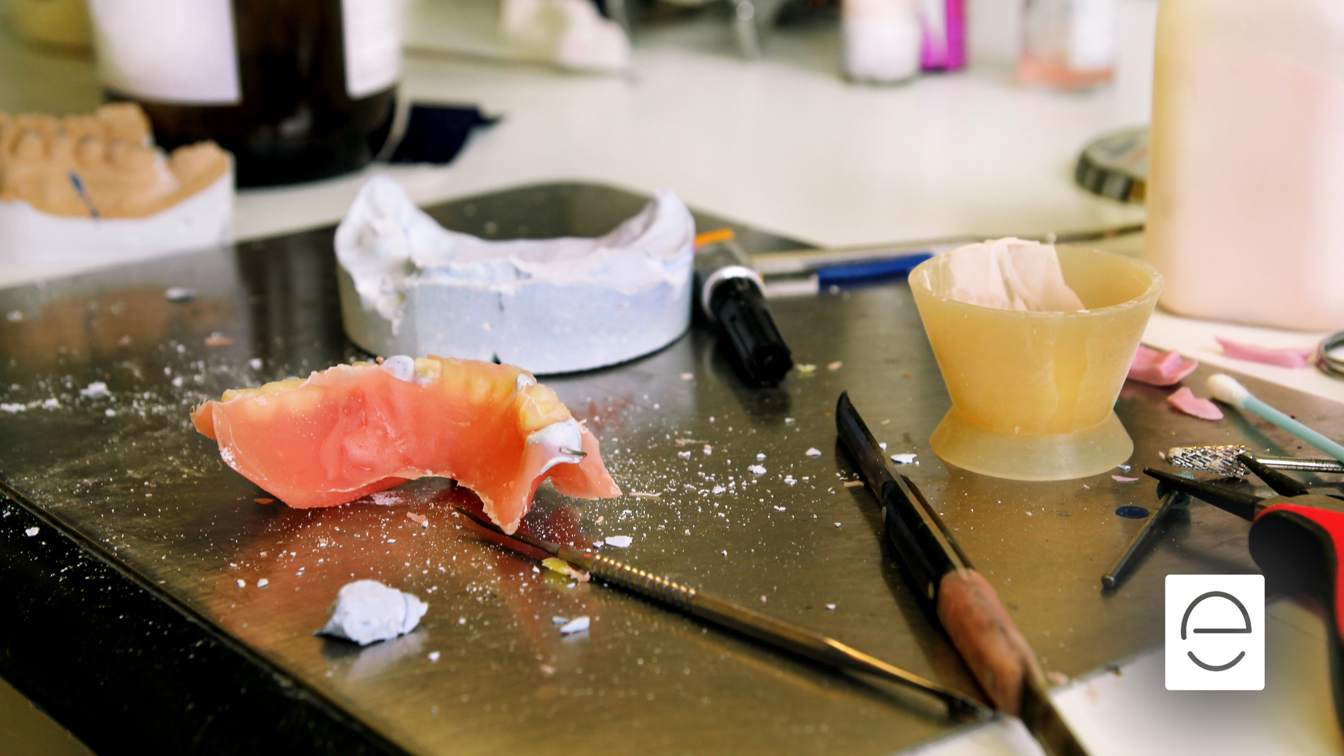 A table with a broken piece of denture on it