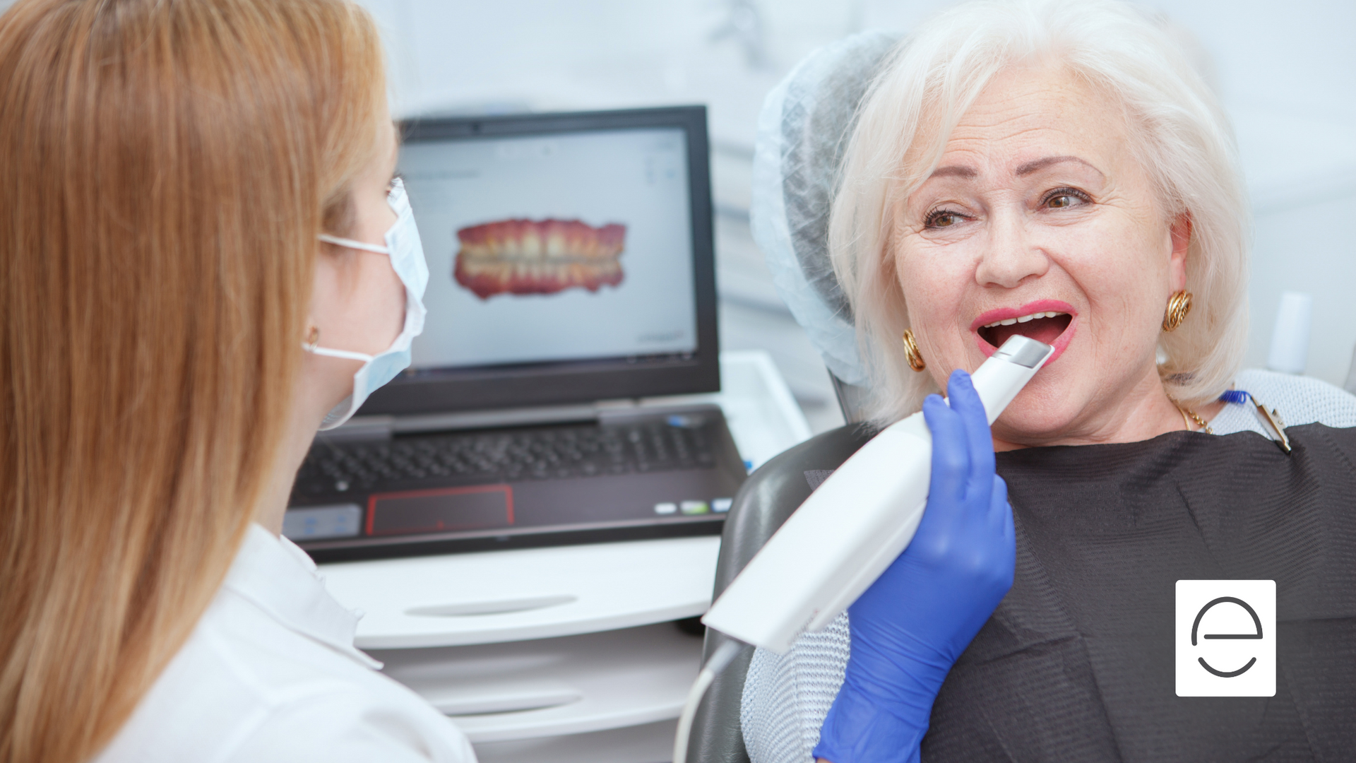 An elderly woman is sitting in a dental chair while a dentist examines her teeth.