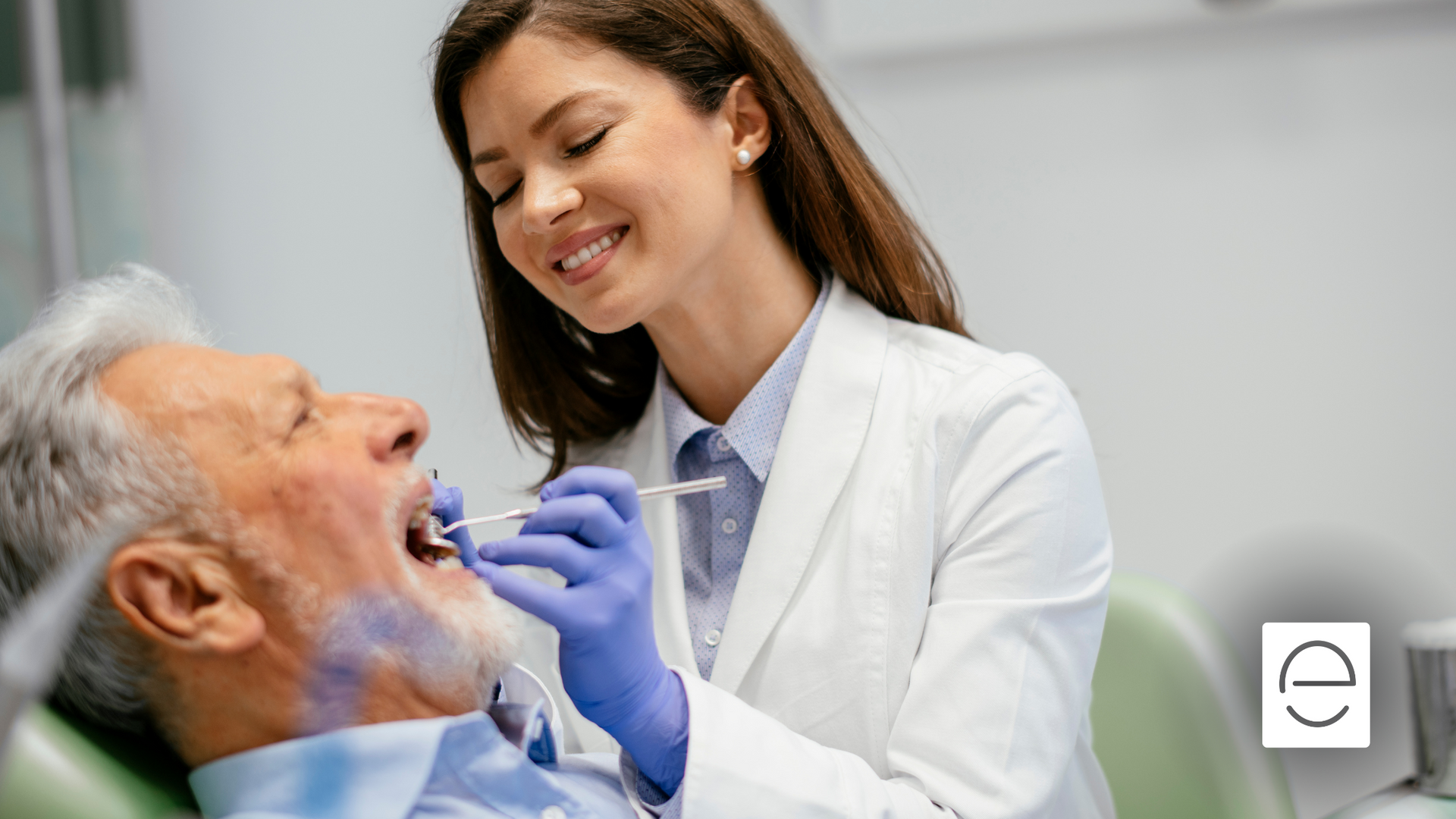 A female dentist is examining an older man 's teeth in a dental office.