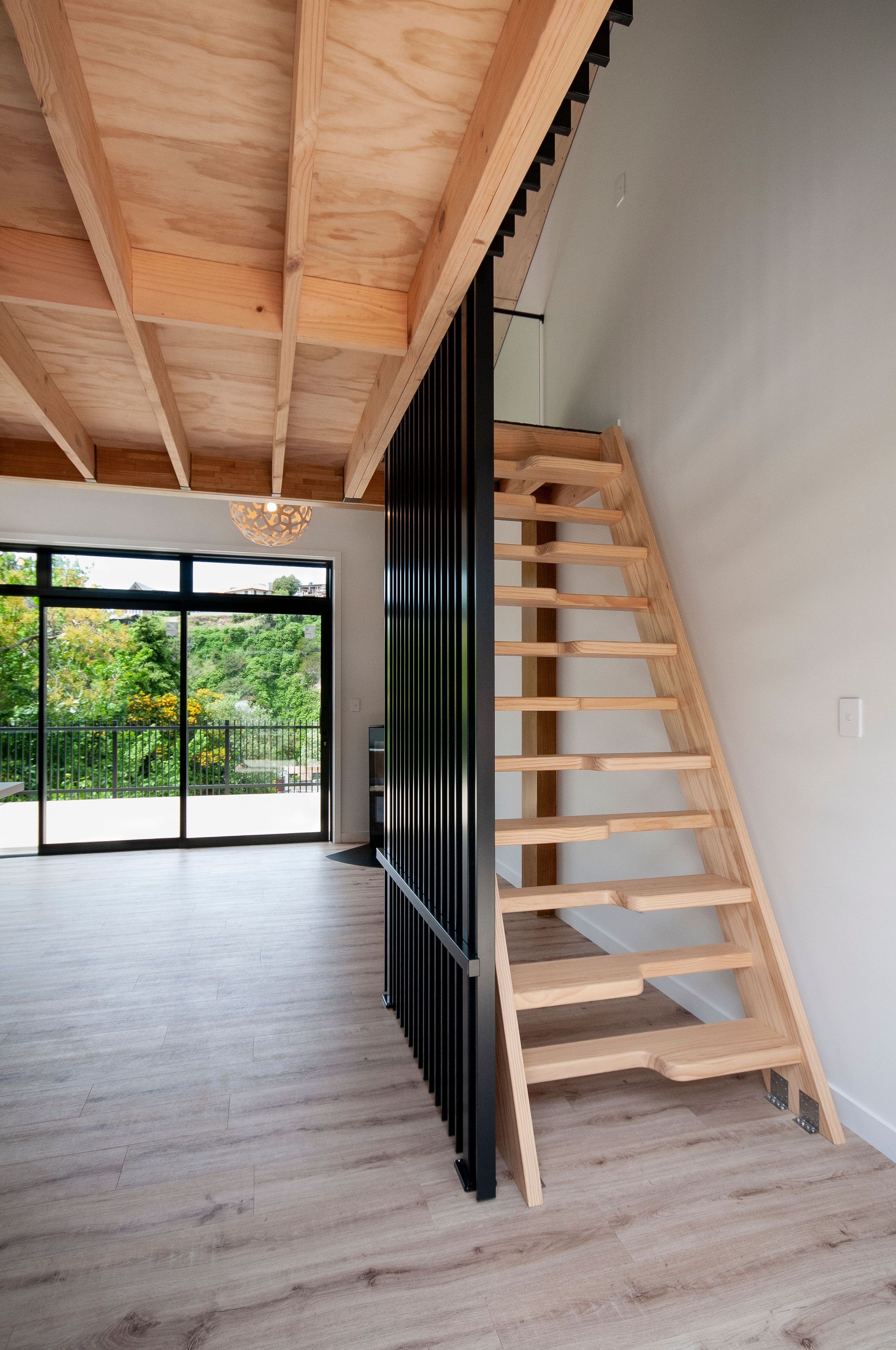 A wooden staircase leading up to the second floor of a house.