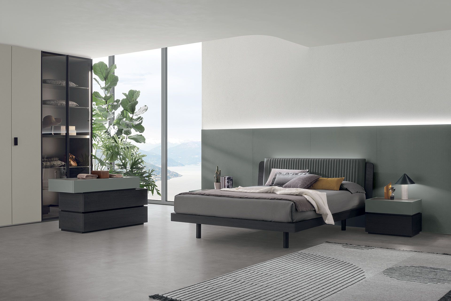 Una camera da letto con un letto, una cassettiera, un comodino e una grande finestra.