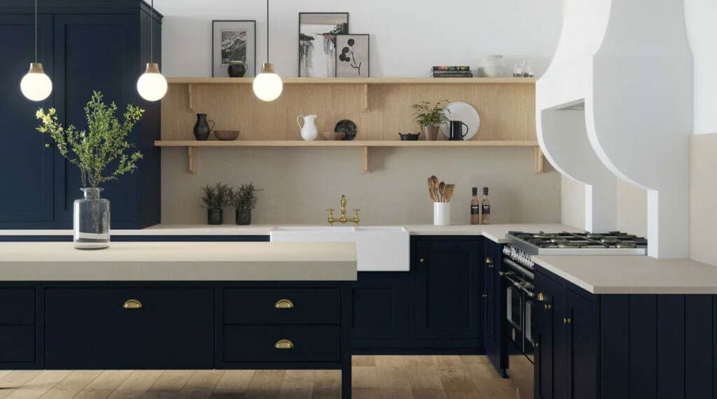 Navy blue kitchen with wooden shelves, cream countertops, and gold hardware.