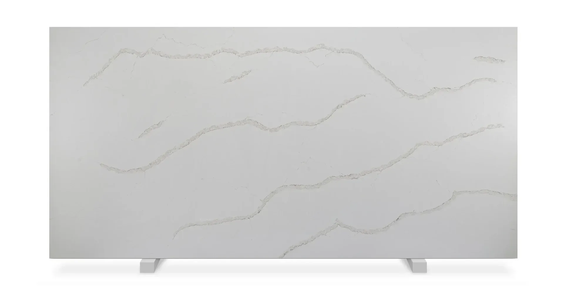 White quartz countertop with wavy gold veining, displayed on supports.