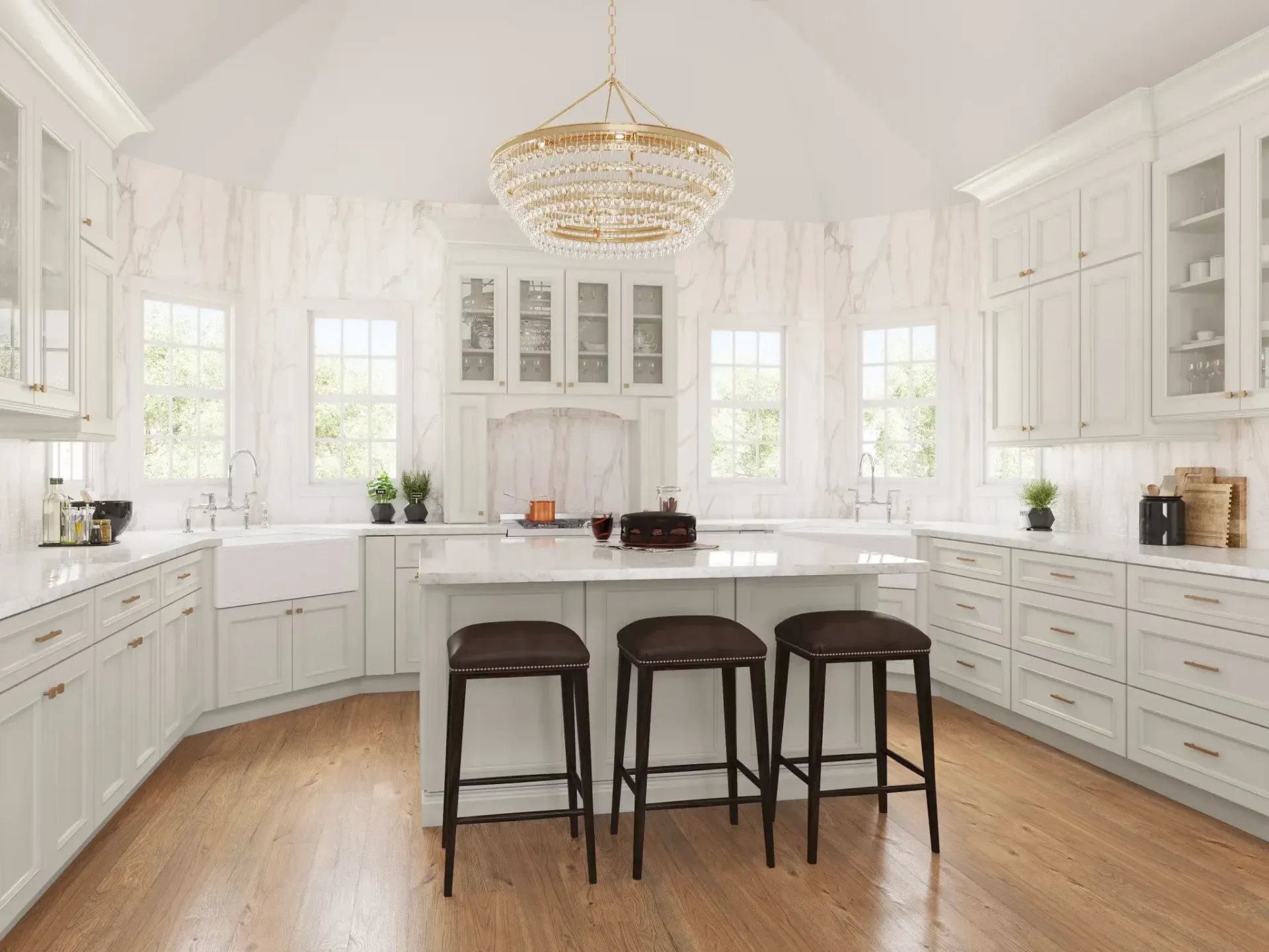 White kitchen with island, wood floor, and gold chandelier, brown leather bar stools.