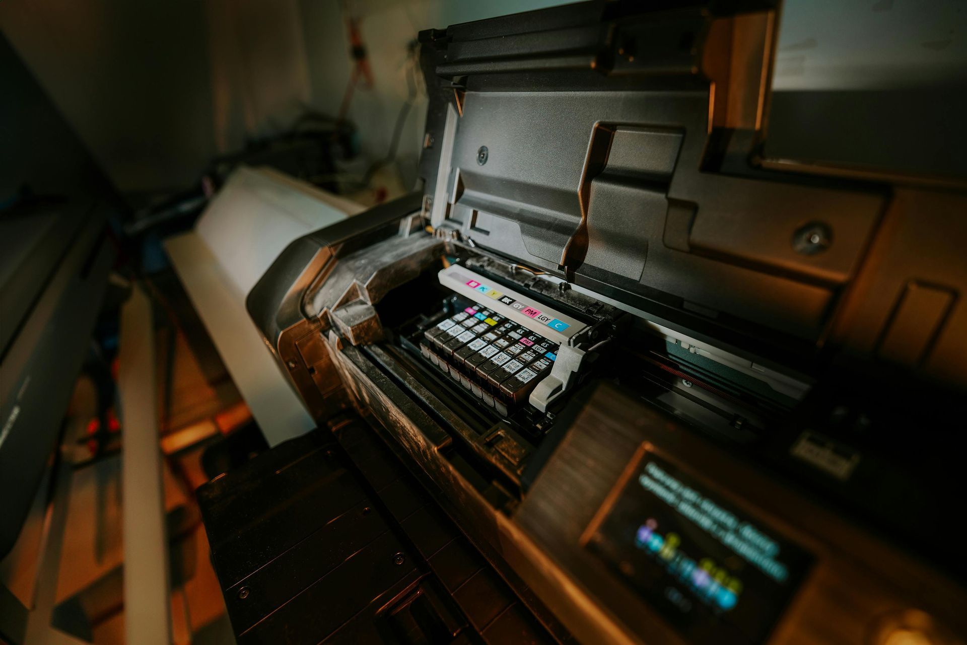 Open printer showing ink cartridges during maintenance service