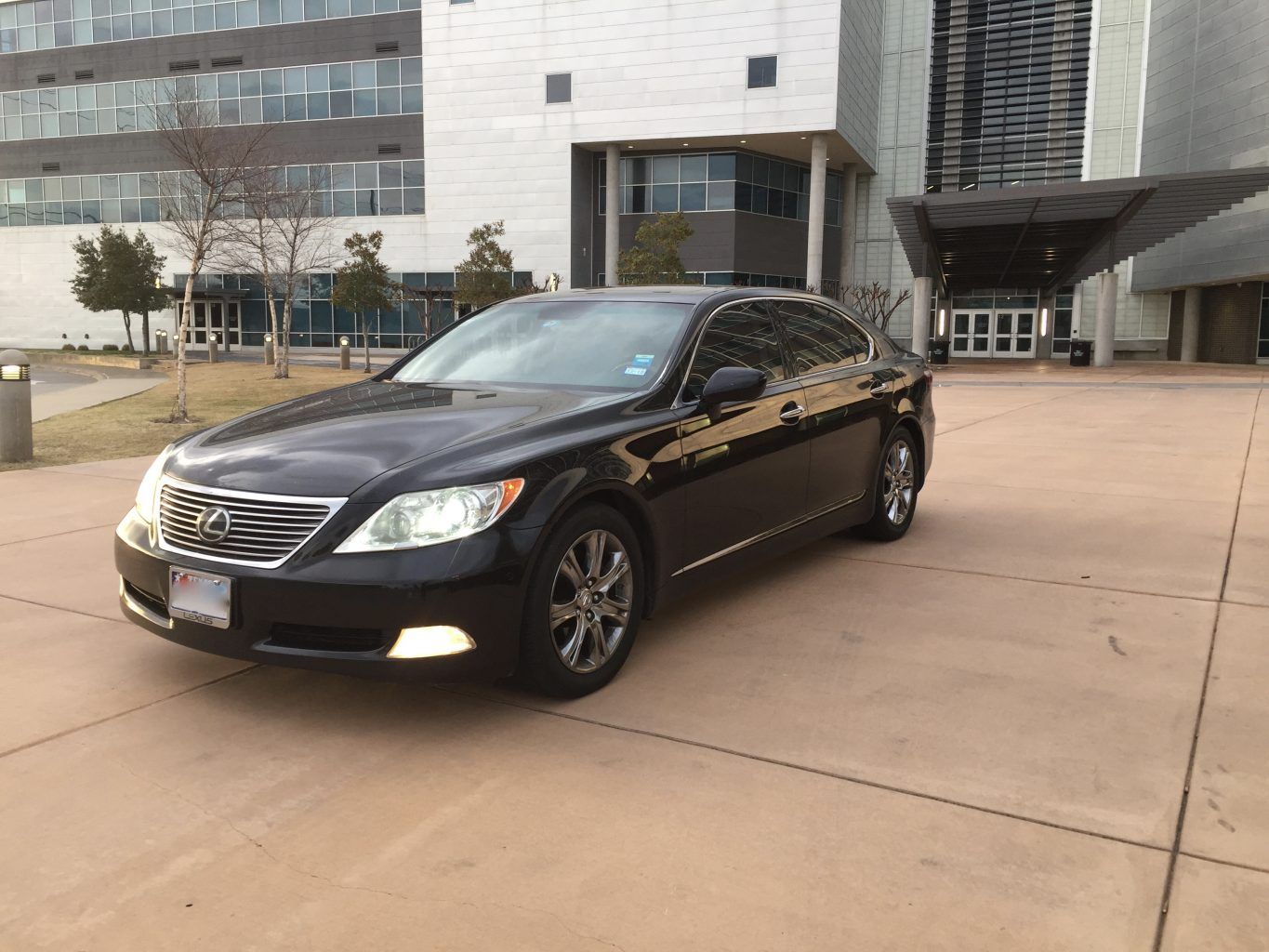 A black car is parked in front of a building