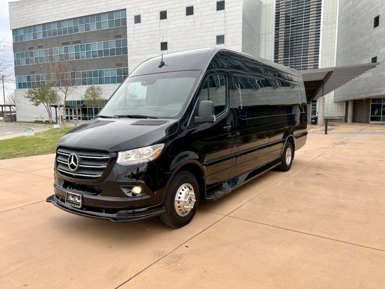 A black van is parked in front of a building.