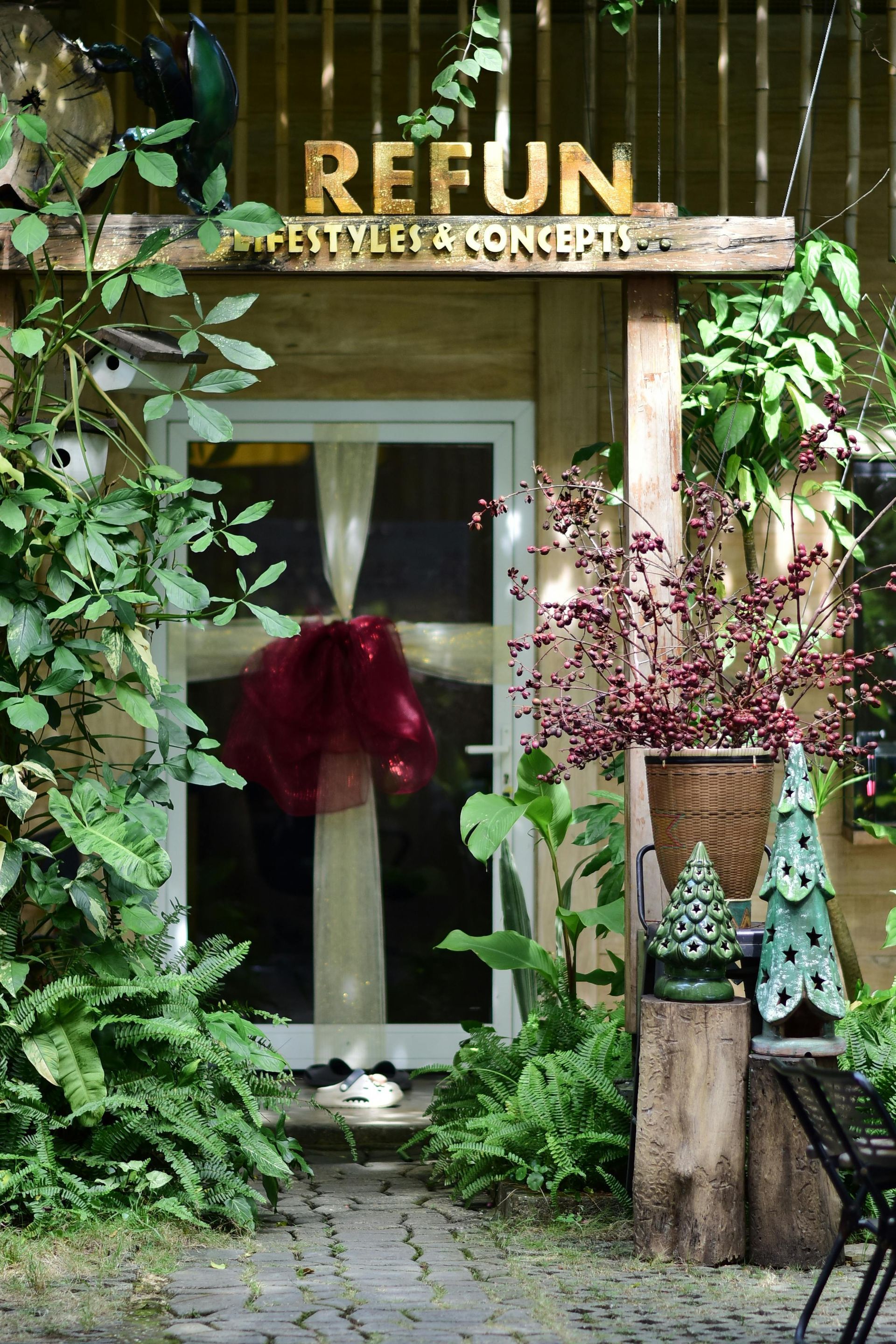 Person lying with head in box, surrounded by moving boxes in empty room.