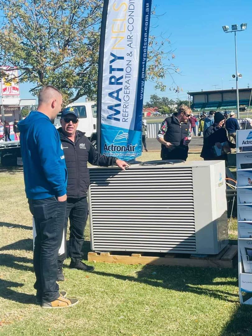 Two Men Examining a Large Air Conditioning Unit 