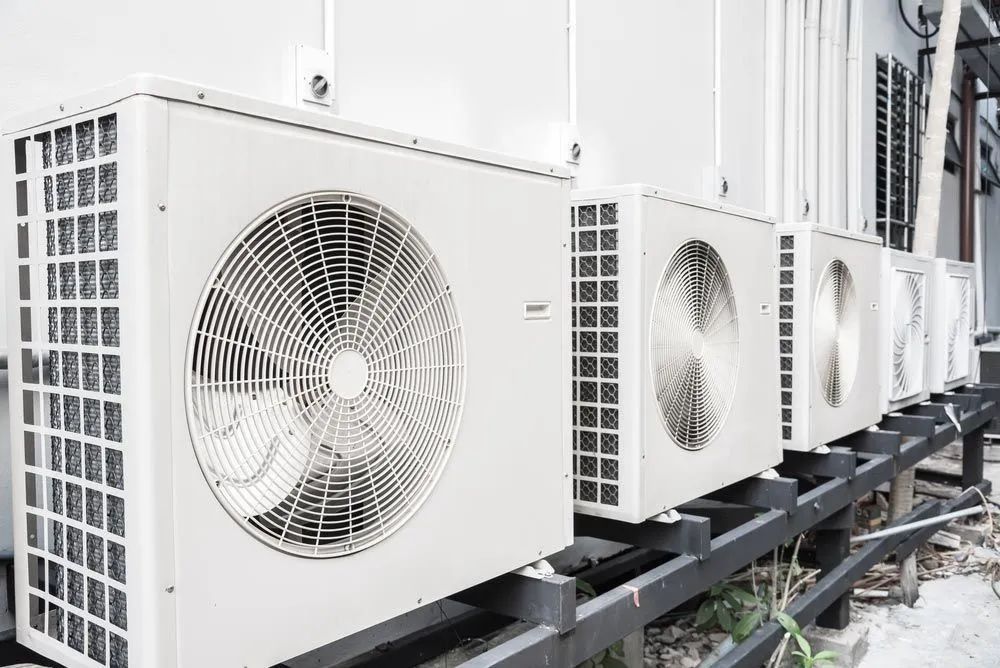 A Row Of Air Conditioners Are Lined Up Outside Of A Building — Marty Nelson Refrigeration & Air Conditioning In Bathurst, NSW