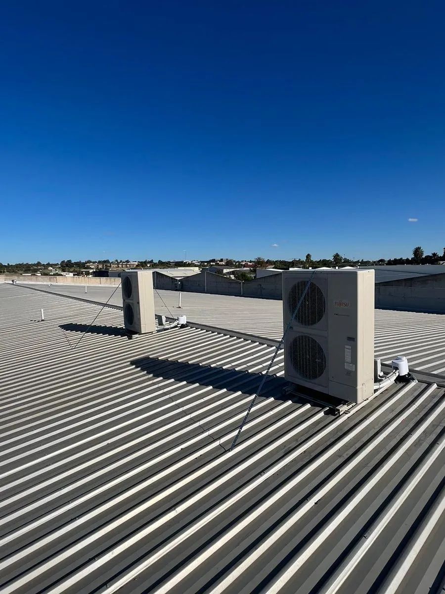 A Roof With Two Air Conditioners In The Background — Marty Nelson Refrigeration & Air Conditioning In Dubbo, NSW