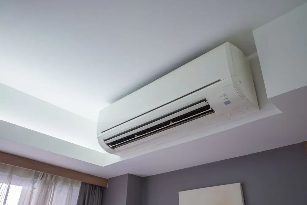 A White Air Conditioner Is Hanging From The Ceiling — Marty Nelson Refrigeration & Air Conditioning In Dubbo, NSW