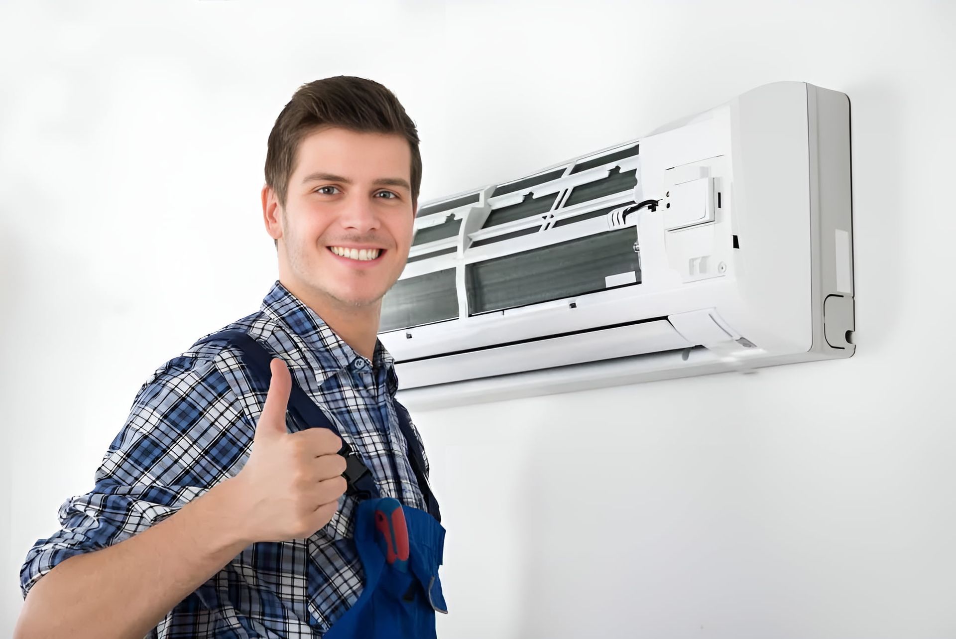 A Man Is Giving A Thumbs Up In Front Of An Air Conditioner — Marty Nelson Refrigeration & Air Conditioning In Dubbo, NSW