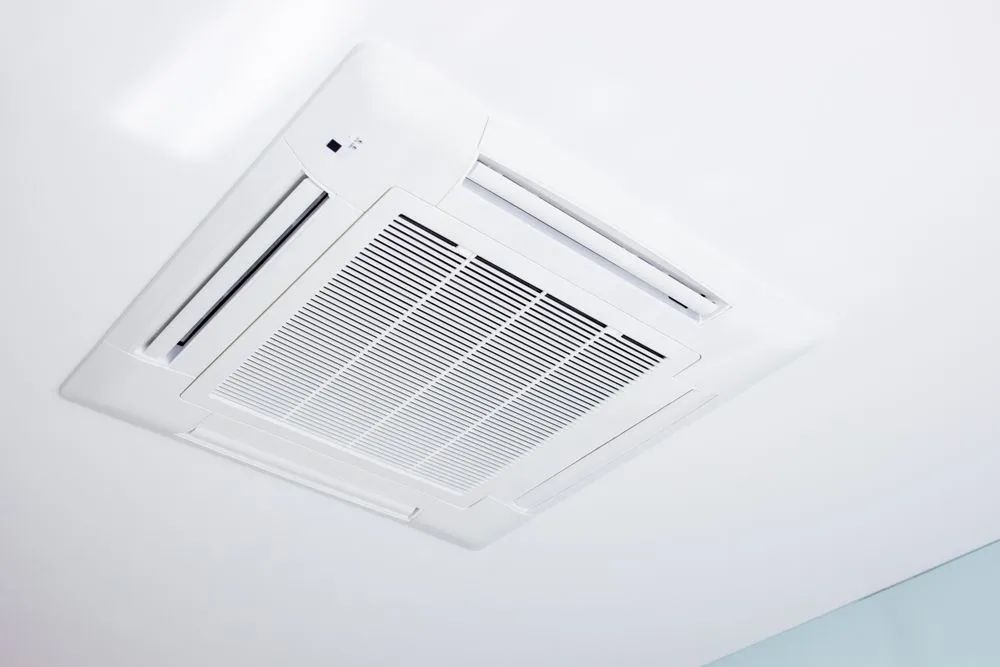 A White Air Conditioner Is Mounted To The Ceiling Of A Room — Marty Nelson Refrigeration & Air Conditioning In Nyngan, NSW