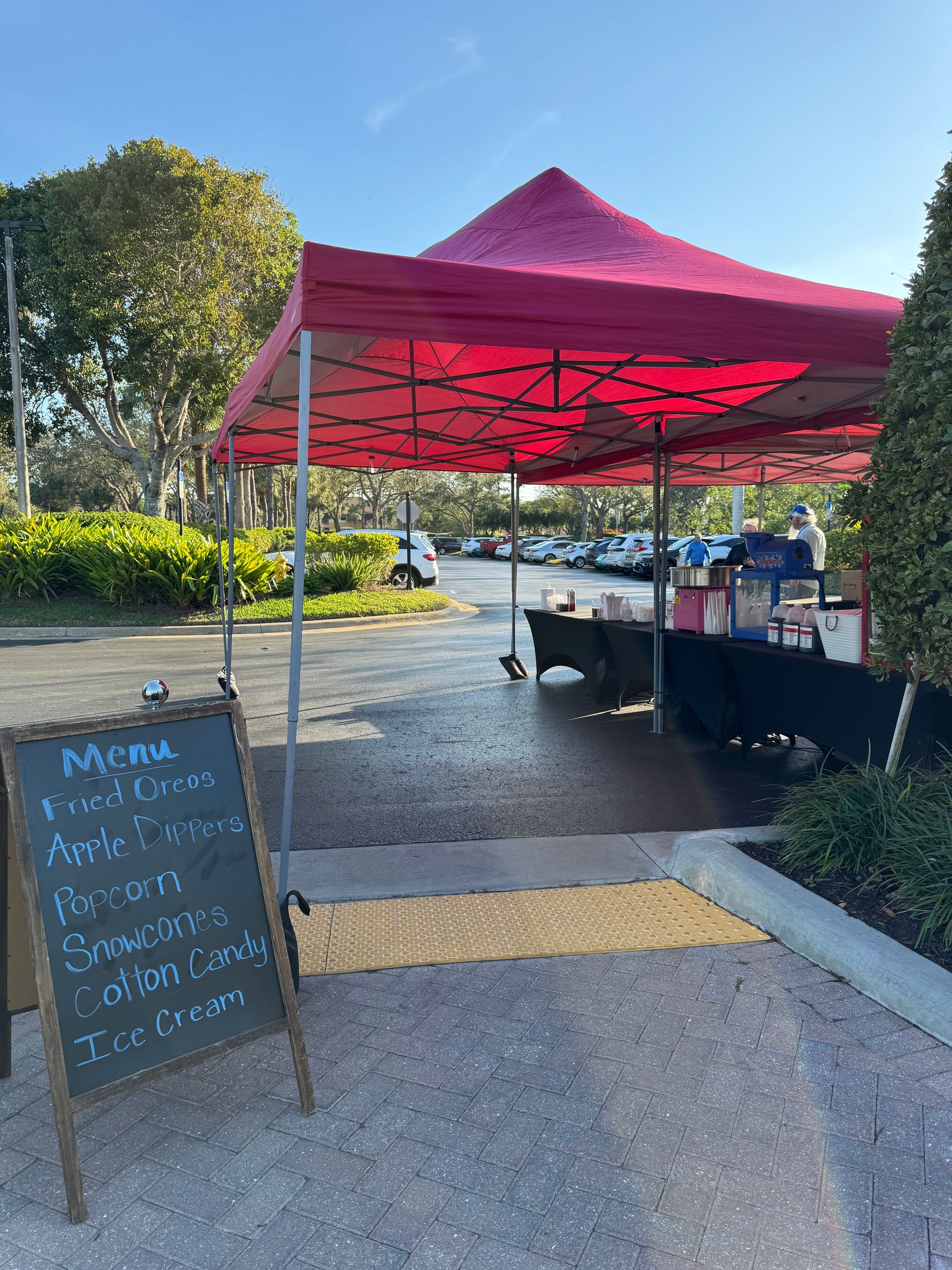Outdoor concession tent with servers and snacks