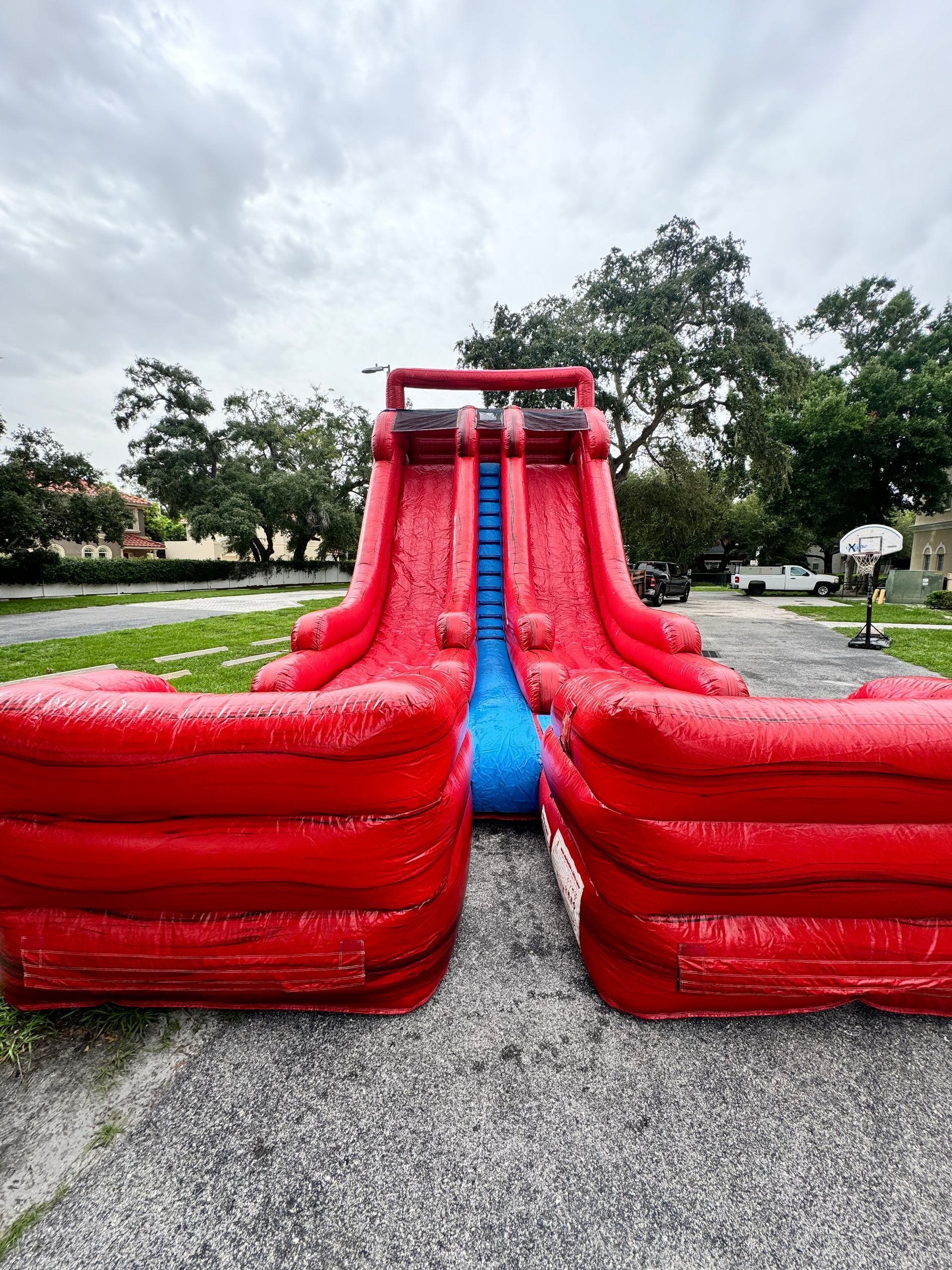 A set of cornhole boards setup on the sand at a beach
