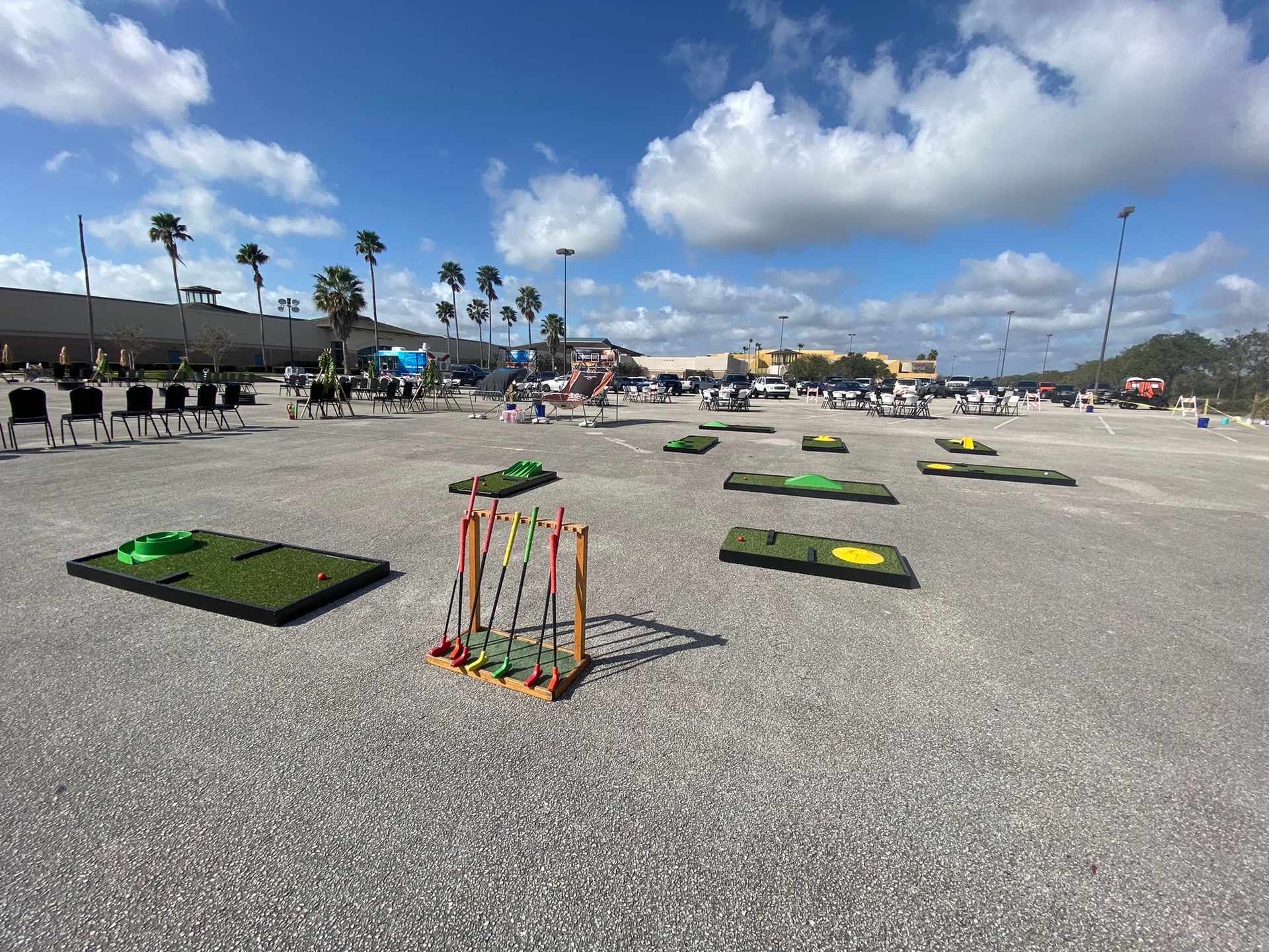 A variety of mini-golf putting greens featuring ramps, loops, and obstacles, designed for outdoor entertainment.