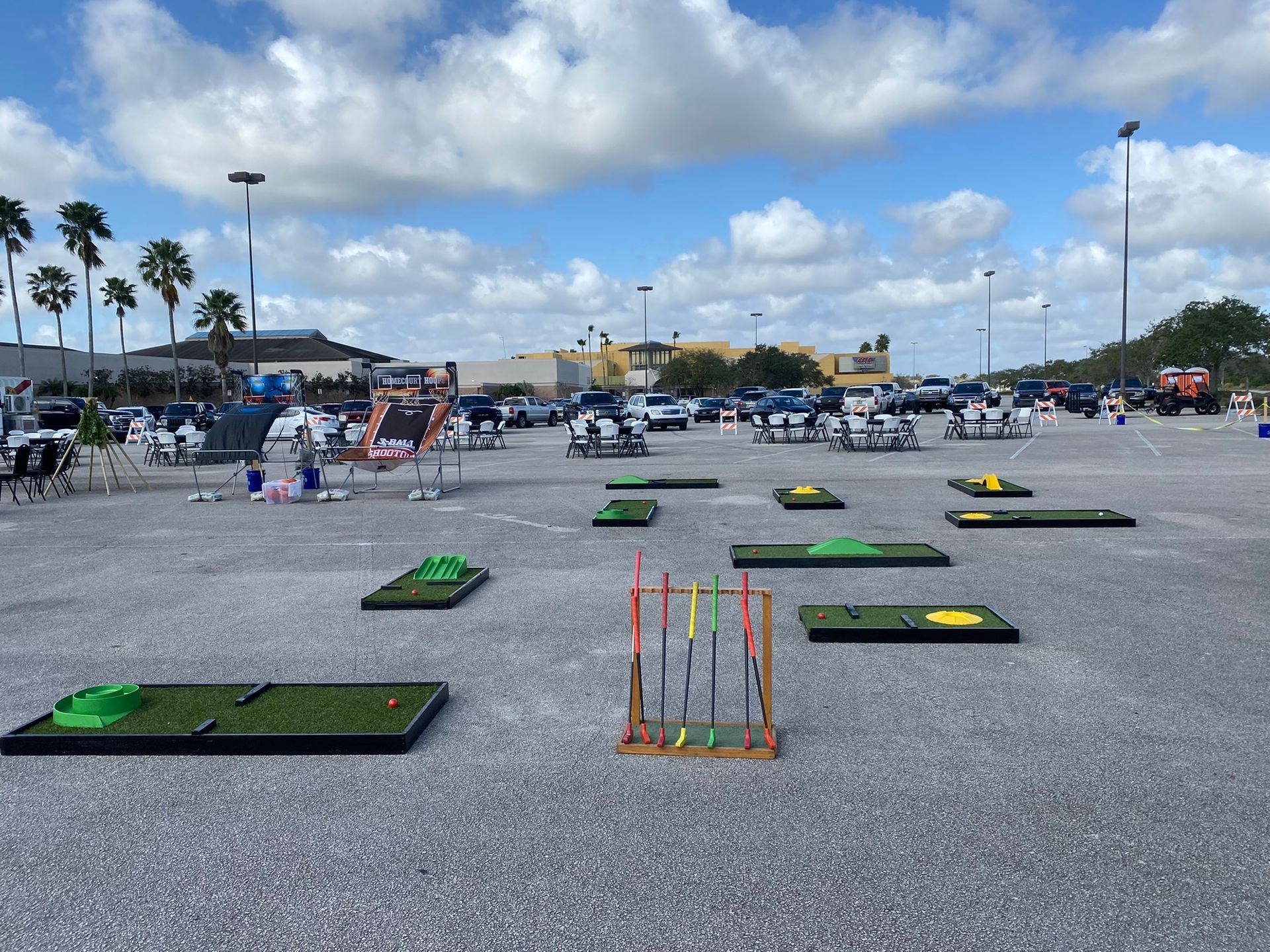 A fun outdoor mini-golf station complete with putters and obstacles, set up for a group event or party.