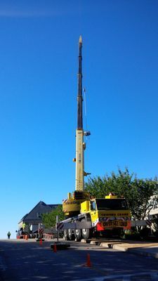 A perspective view of the crane boom fully extended, showcasing the scale of the industrial lifting operation.
