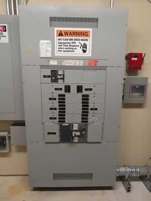 A close-up of a main electrical breaker panel with various switches and a 