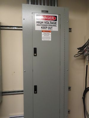 A tall, closed grey electrical panel with a 