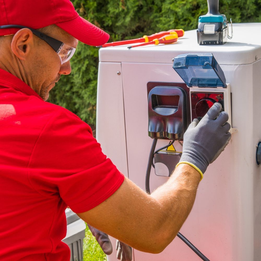 Specialist adjusting the electrical disconnect switch and exterior power supply for a heat pump.