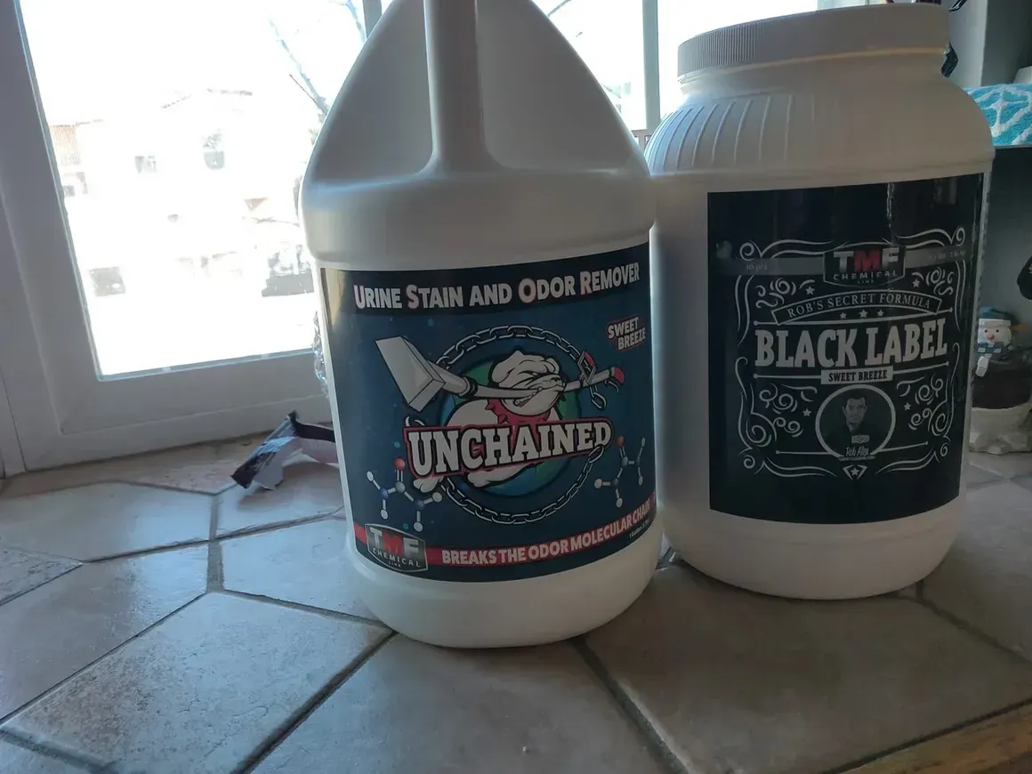 Two bottles of cleaning products are sitting on a tiled counter.