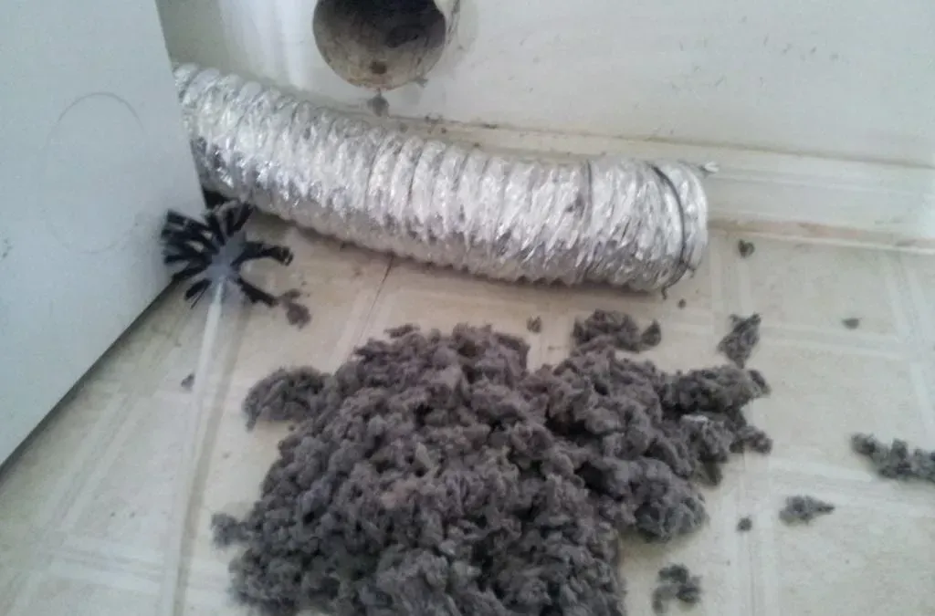 A bunch of dust is coming out of a duct on the floor.
