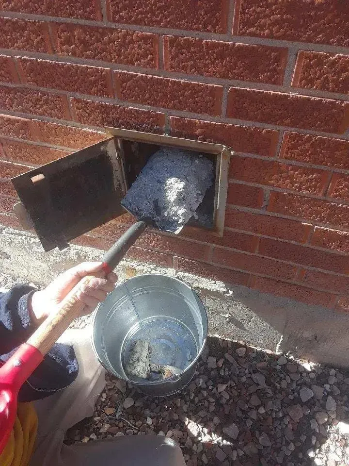 A group of people are standing on top of a hill with a dog.