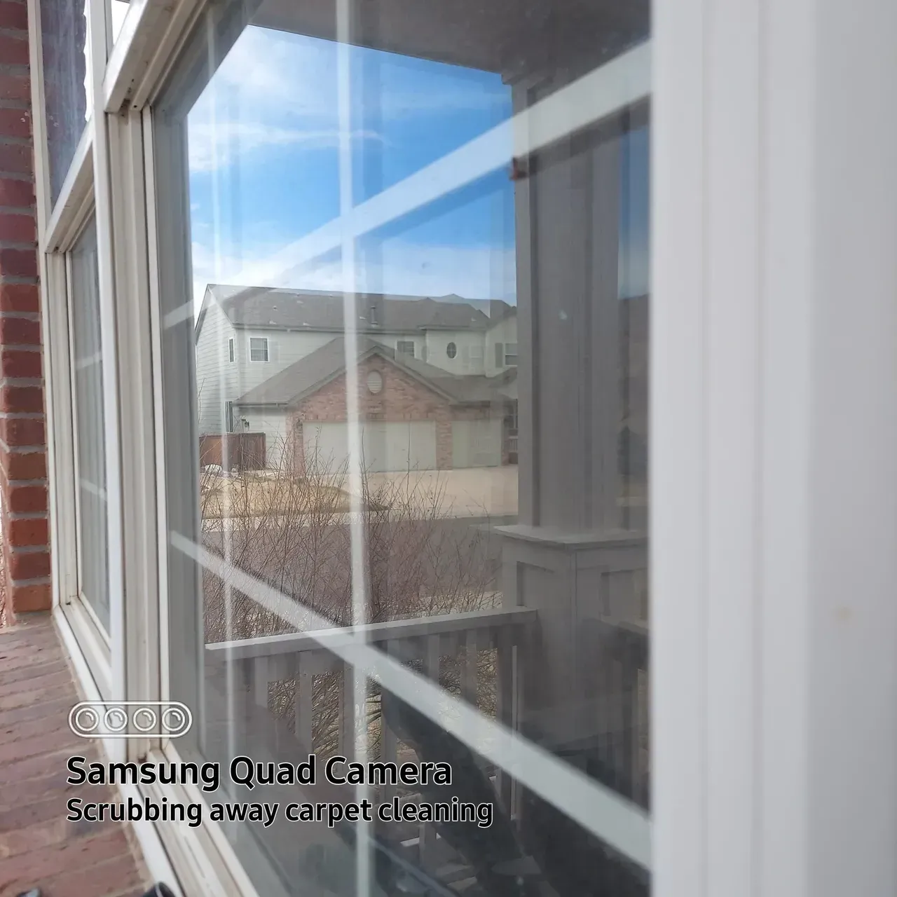 A samsung quad camera is taking a picture of a window