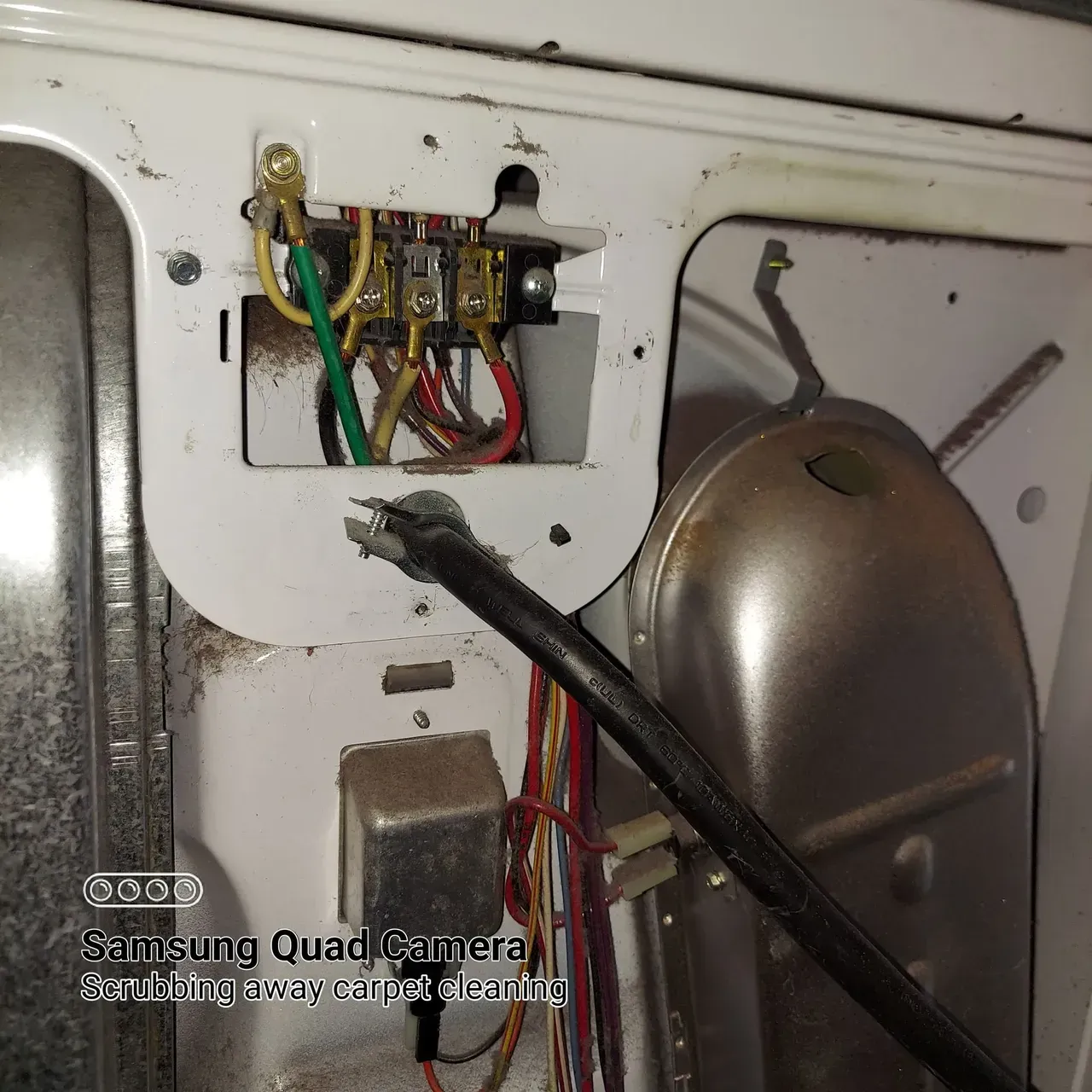 A picture of a washing machine taken by a samsung quad camera