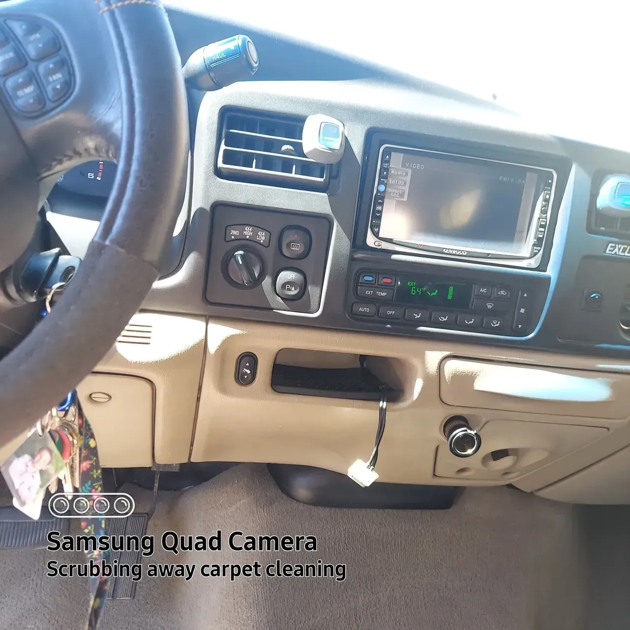 A samsung quad camera shows the interior of a car