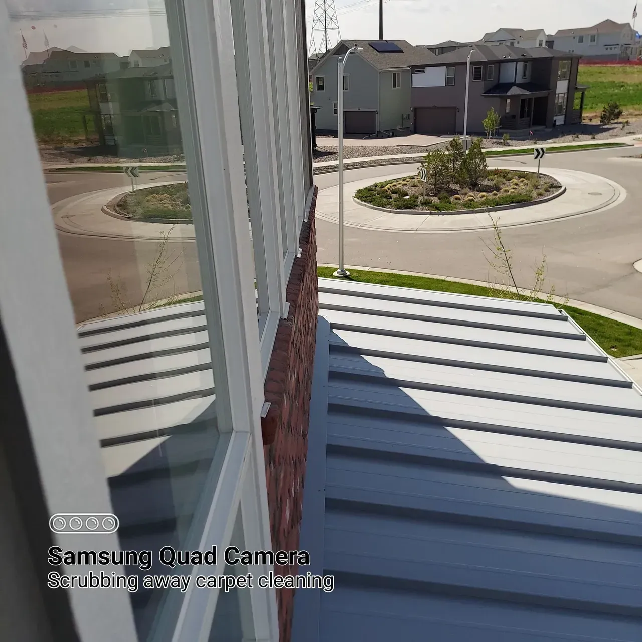 A samsung quad camera takes a picture of a brick building