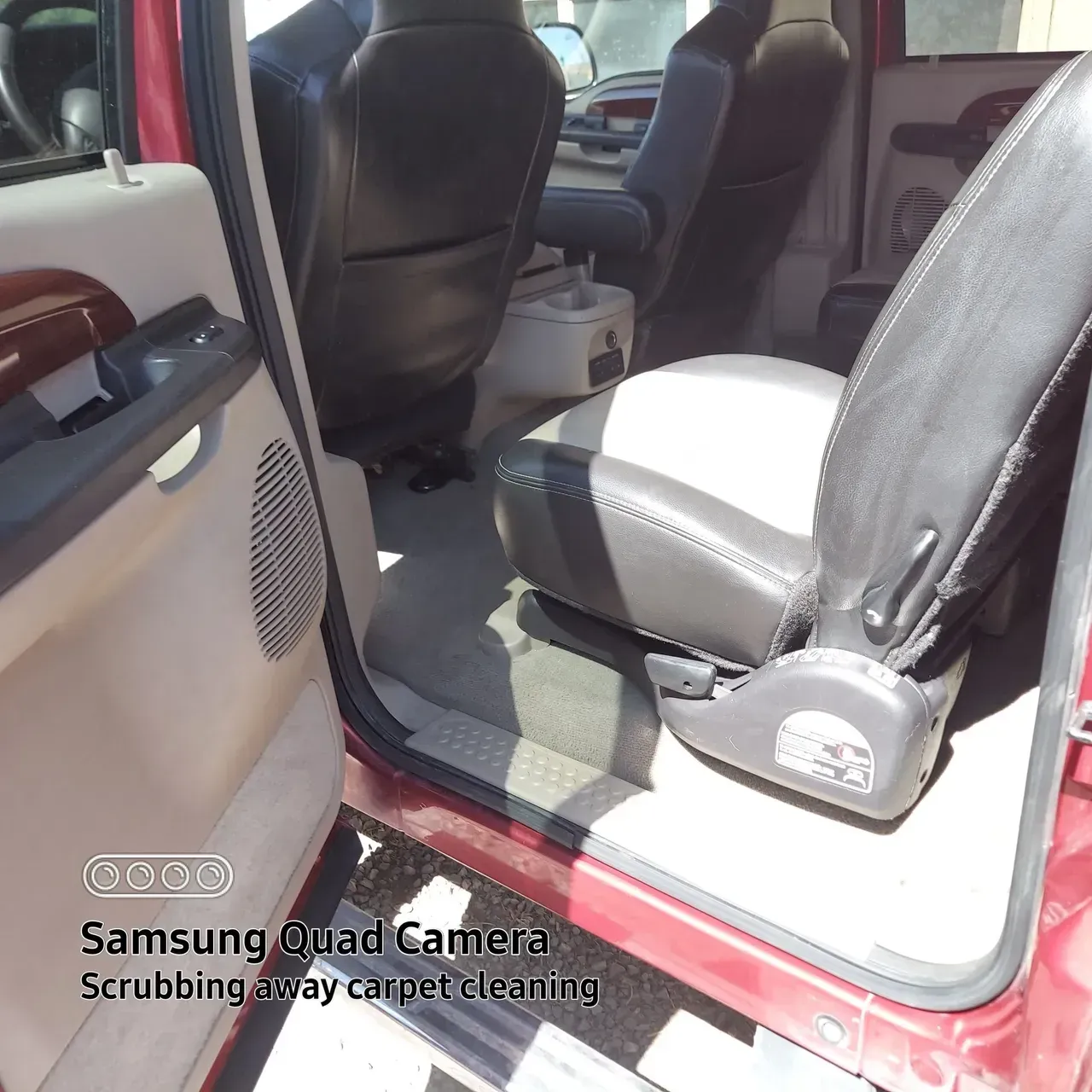 The inside of a red car with a samsung quad camera