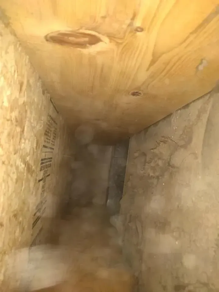 A close up of a wooden ceiling in a room.