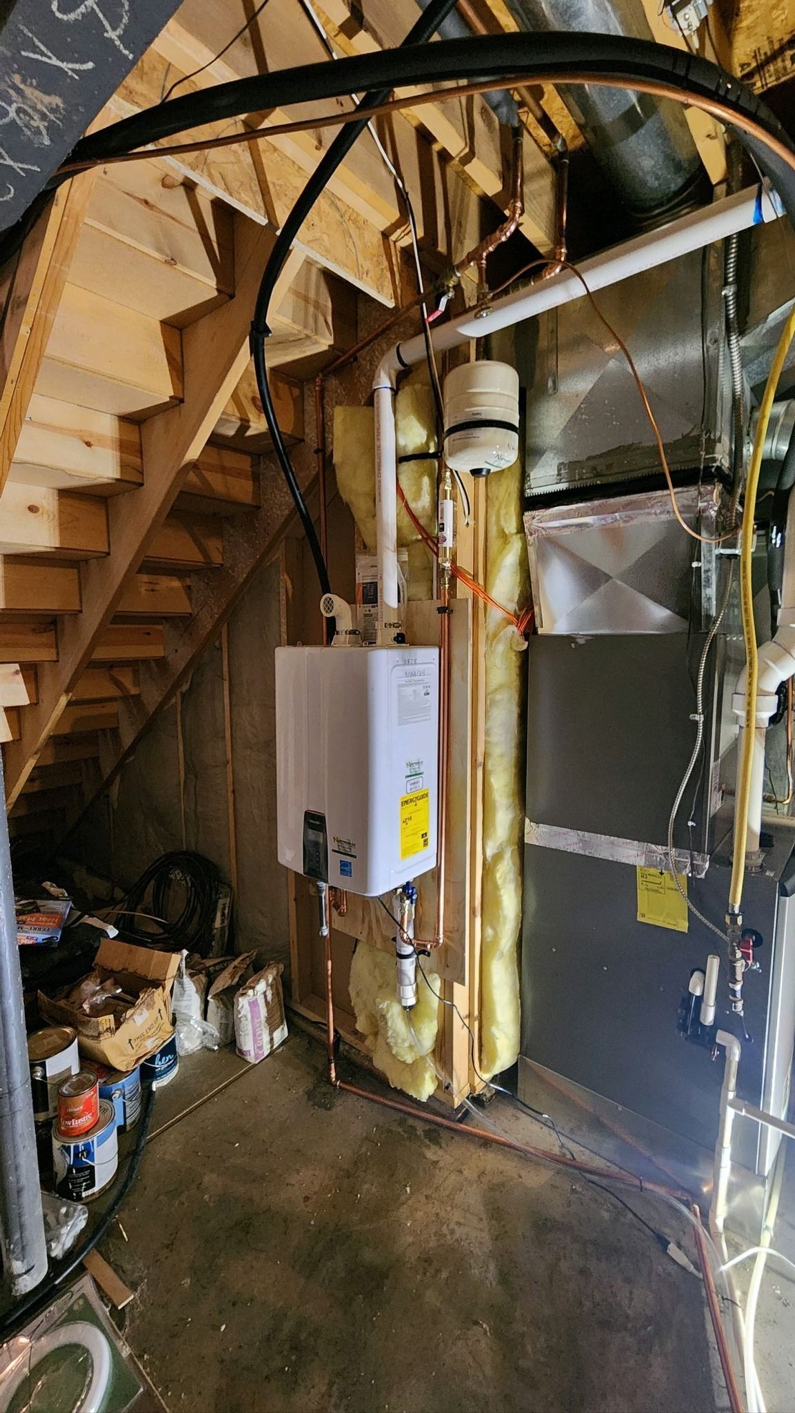 There is a water heater in the corner of the room.