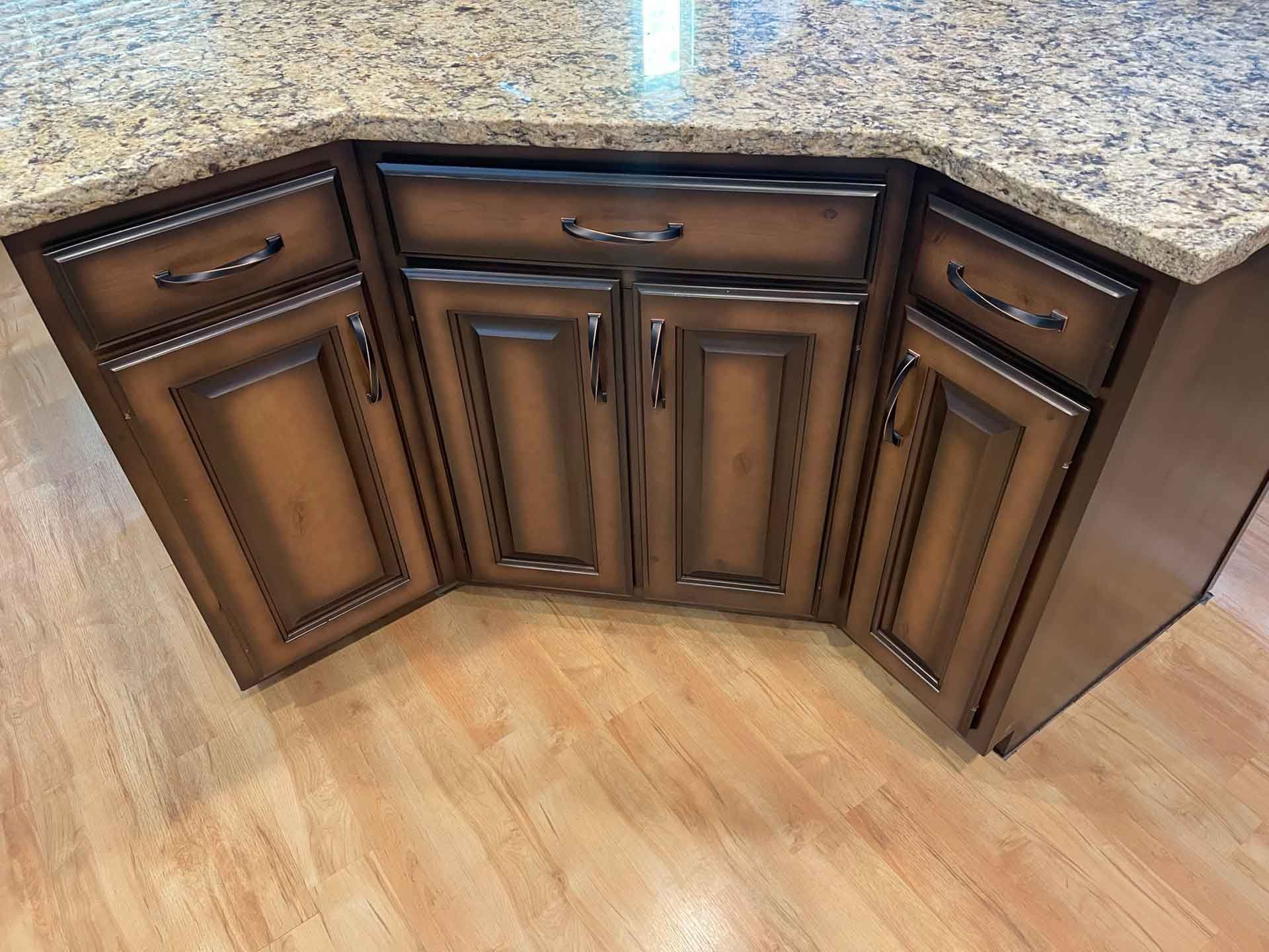 A kitchen with wooden cabinets and granite counter tops