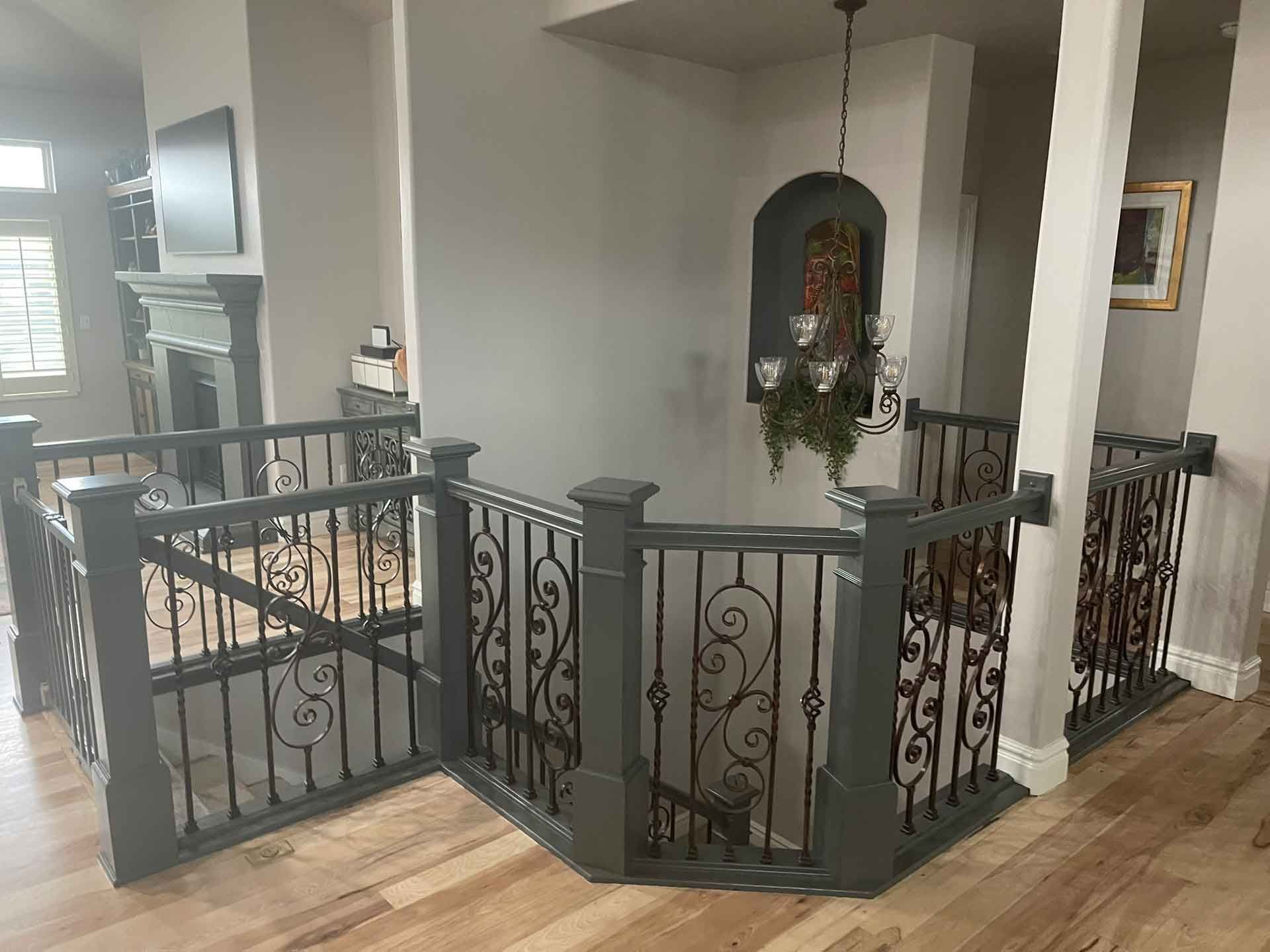 A staircase with a wrought iron railing in a house.