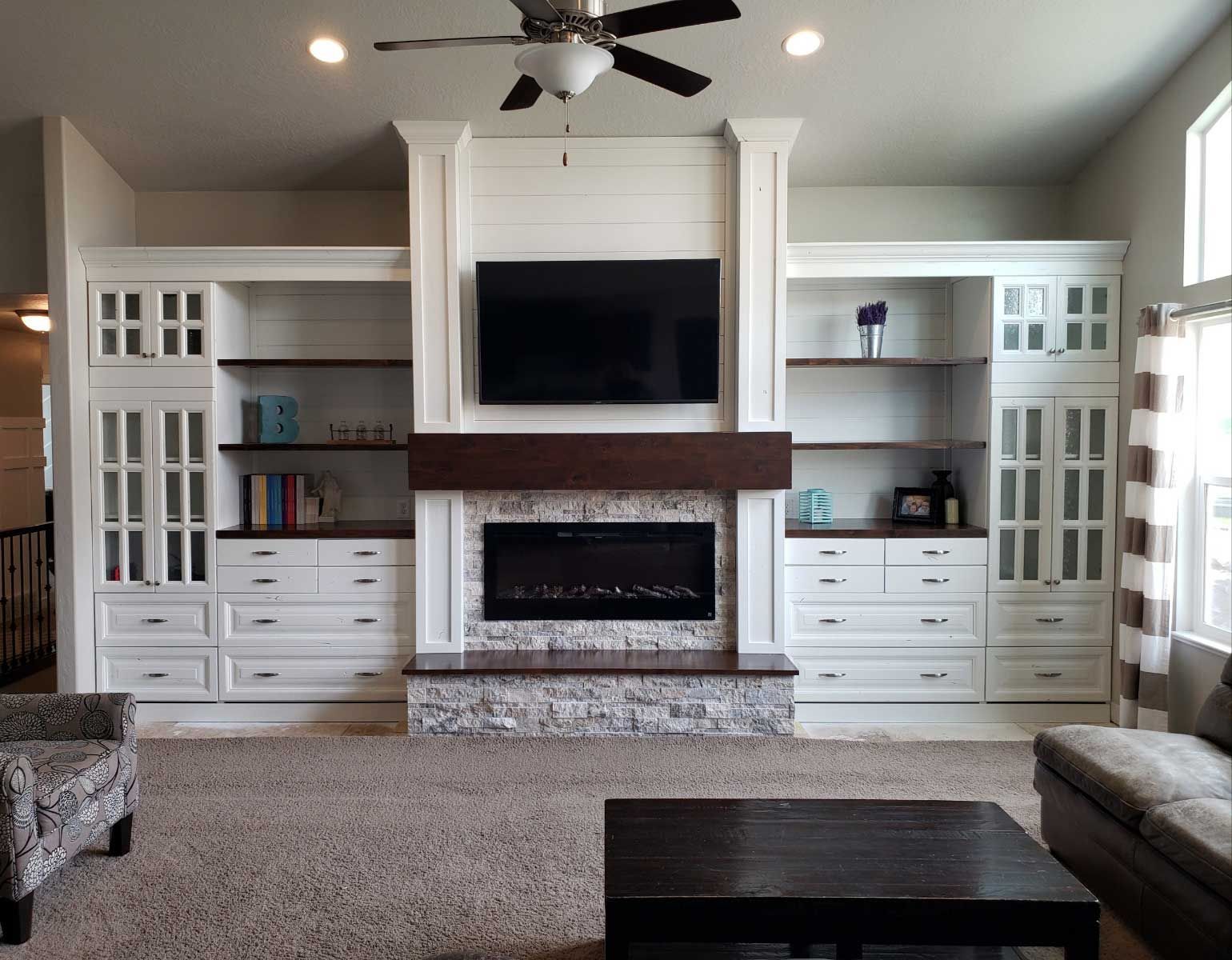 A living room with a fireplace and a flat screen tv